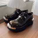 Patent leather platform shoes with metallic toe-cap accents and chunky rubber sole in brown, navy, and black color options.