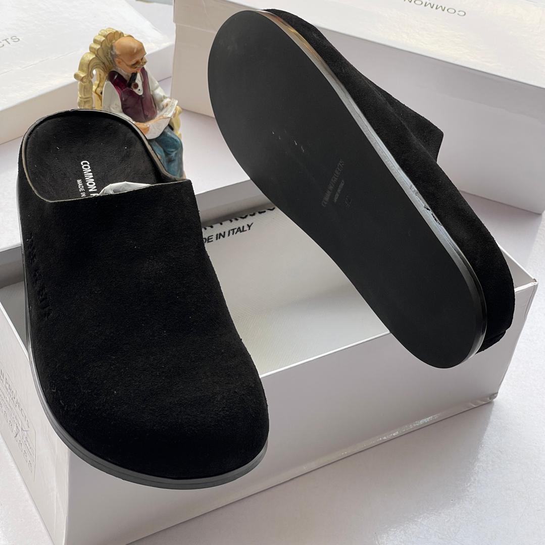 Common Projects suede mule slides Common Projects men's burgundy suede slip-on mule slides with a black rubber sole, displayed in a white branded shoebox.