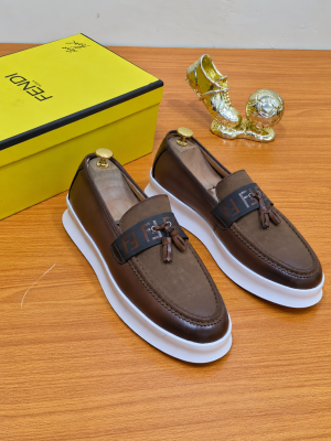 Fendi men’s dark brown leather loafer with FF logo strap, tassel detail, and white platform sole — luxury statement slip-on for urban style, boardroom edge, and high-end streetwear.