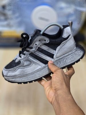 men's luxury grey suede sneaker with green stripes and laces, showcasing its premium texture and chunky sole design.