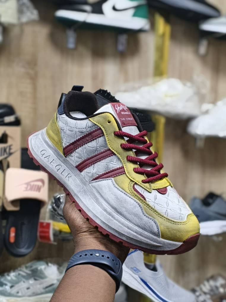 Men’s Luxury Suede Sneakers men's luxury grey suede sneaker with green stripes and laces, showcasing its premium texture and chunky sole design.