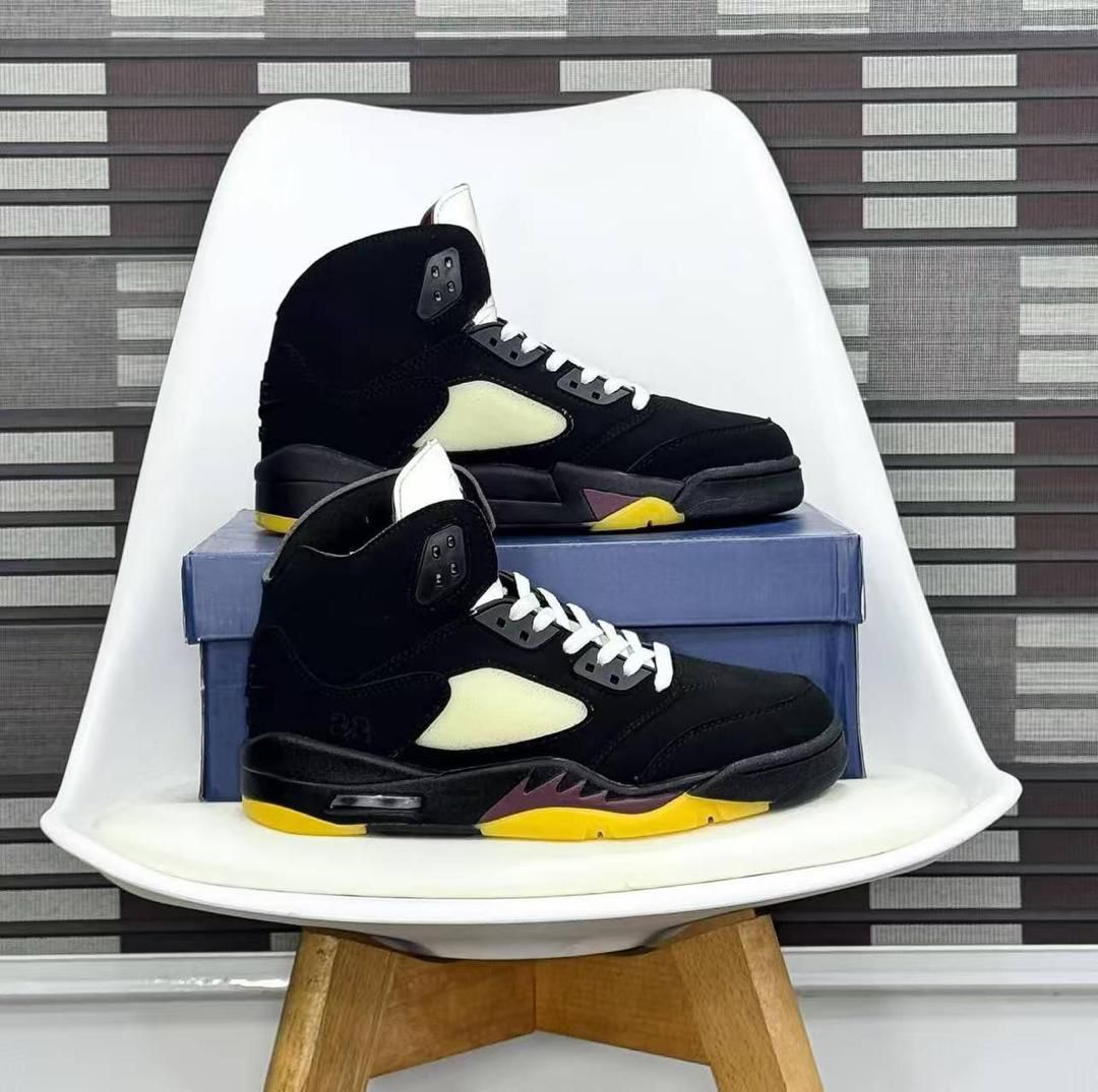 Nike Air Jordan 5 – Premium Leather & Suede High-Top Sneaker Nike Air Jordan 5 “Black Grape” high-top sneaker in black suede and leather with translucent blue outsole and purple lace lock