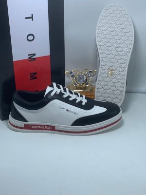 Brown and tan Tommy Hilfiger leather sneakers with white sole and red stripe detail - luxury men's casual shoes.