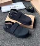 Black Zara leather sandals with velcro strap and ankle buckle displayed with Zara packaging on grey carpet