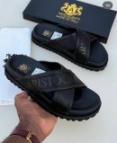 Black Aristocrats Luxury cross-strap slides with rugged sole and Made in Italy branding displayed with black box and dust bag.