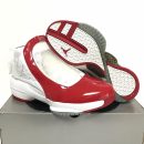 White and red Air Jordan 11 "Win Like '82" sneakers with patent leather mudguard and translucent outsole displayed on shoe box.