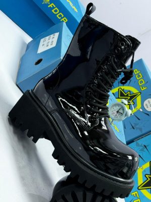 Black FDCR patent leather combat boots with chunky lug sole displayed with blue FDCR boxes.