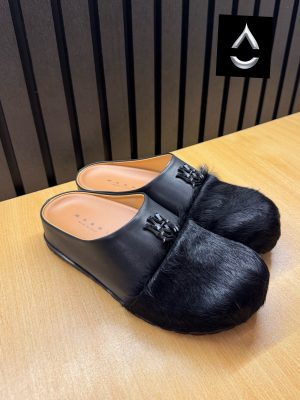 AMIRI luxury fur slide mules in white, black, and brown with authentic leather upper, plush fur detailing, signature AM logo, and cushioned sole displayed with original black AMIRI box