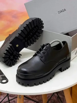 black leather Balenciaga Triple S platform oxfords with a sleek upper