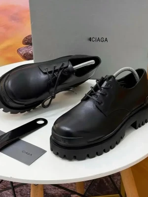 black leather Balenciaga Triple S platform oxfords with a sleek upper