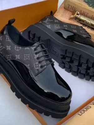 black Louis Vuitton monogram platform oxfords with a glossy patent leather toe cap, iconic LV print on the sides, and thick rugged sole,