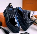 black Louis Vuitton monogram platform oxfords with a glossy patent leather toe cap, iconic LV print on the sides, and thick rugged sole,
