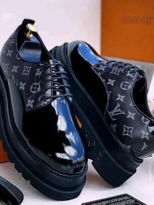 black Louis Vuitton monogram platform oxfords with a glossy patent leather toe cap, iconic LV print on the sides, and thick rugged sole,