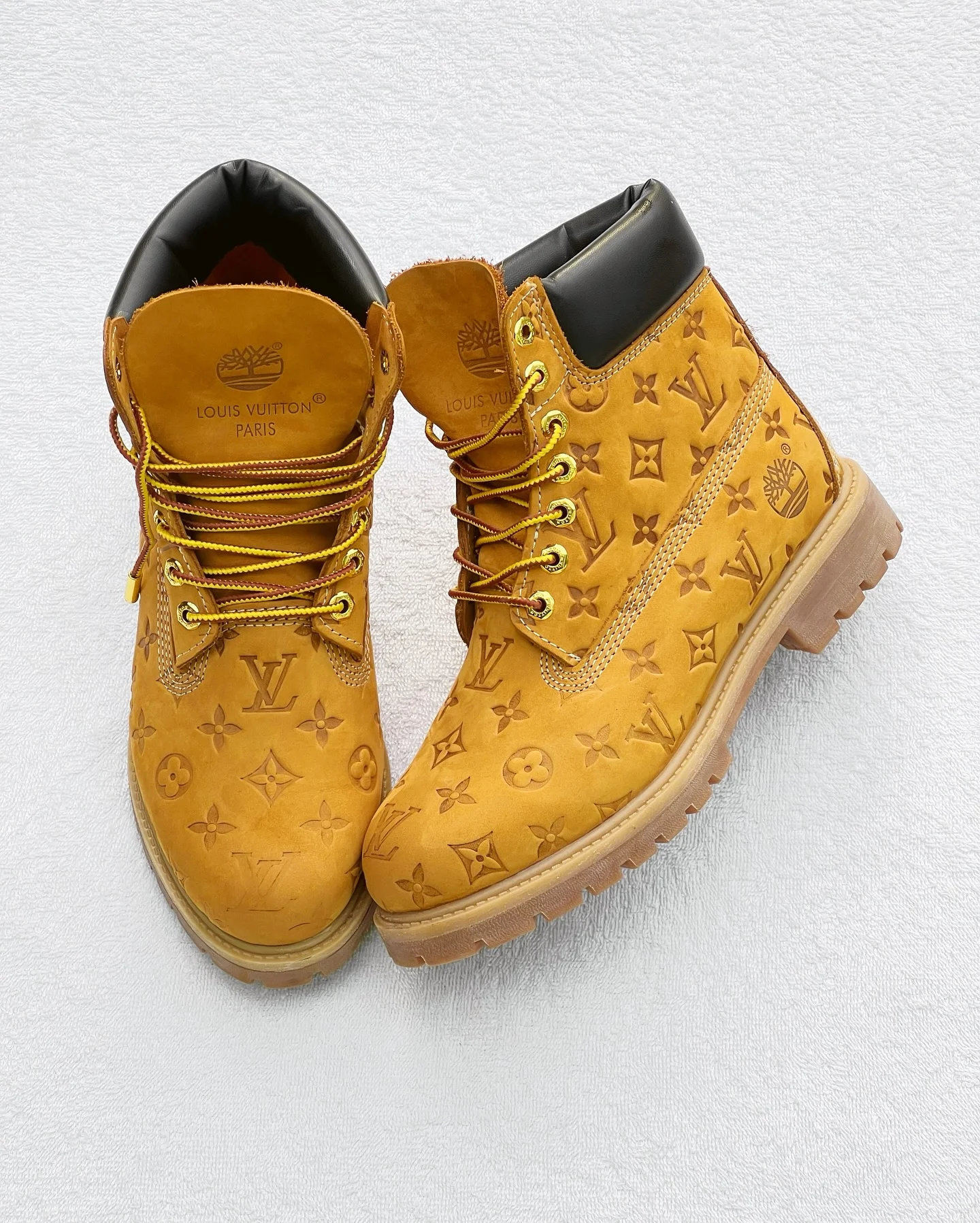 Men’s Luxury Designer Boots - Tan Monogram Style A pair of men's luxury tan designer boots with a distinctive pattern, displayed on orange boxes with branded packaging, showcasing their bold design and thick, cushioned sole. Copy Ask Explain Translate(en-US)