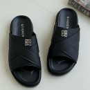 A pair of men's luxury black leather slides and a pair of grey leather slides, displayed on a wooden surface with premium packaging, showcasing their sleek design and premium material.