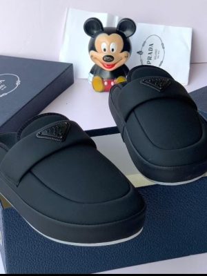 Prada men’s matte black neoprene slip-on slide with signature triangle logo and cushioned sole — luxury comfort slide for poolside, weekend flex, and high-end indoor-outdoor wear.