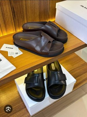 Authentic Jil Sander slide sandal in brown with full-grain leather straps and branded insole - Swingdot Luxe Original Jil Sander luxury slide sandal showcasing precise stitching and verified authenticity - 100% genuine Nigeria Jil Sander slide sandal with embossed logo and durable sole construction - Swingdot Luxe authentic footwear