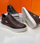 Brown leather Lacoste high-top sneakers with woven texture, gold crocodile logo, and white chunky platform sole - luxury men's streetwear shoes