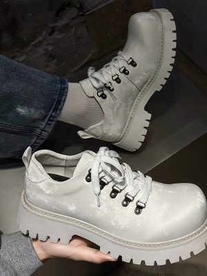 Light grey leather platform sneakers with chunky white lug sole and metal eyelets - luxury men's streetwear shoes with distressed finish