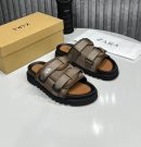 Zara men's taupe tactical slide sandals with double adjustable straps, white logo branding, and chunky black rubber lug sole, displayed with branded box and dust bag on white surface.