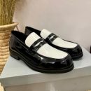Black and white two-tone patent leather penny loafers with high-gloss finish - luxury men's formal shoes with contrasting color block design