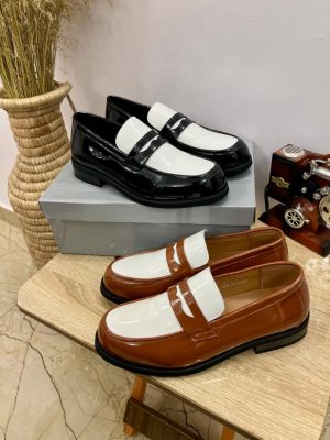 Black and white two-tone patent leather penny loafers with high-gloss finish - luxury men's formal shoes with contrasting color block design