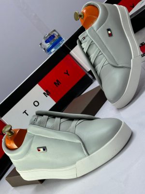 Navy blue leather Tommy Hilfiger sneakers with white platform sole and elastic criss-cross straps - luxury men's slip-on shoes with flag logo