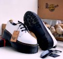 White leather Dr. Martens platform shoes with black chunky lug sole and yellow stitching - luxury men's alternative fashion shoes