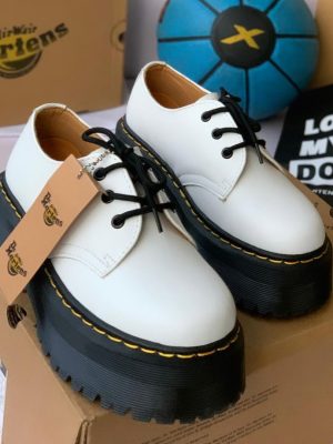 White leather Dr. Martens platform shoes with black chunky lug sole and yellow stitching - luxury men's alternative fashion shoes
