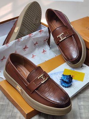 Black textured leather Louis Vuitton loafers with gold-tone hardware and chunky black lug sole - luxury men's designer shoes.