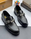 Black Louis Vuitton leather loafers with silver bone buckle hardware displayed with LV box and dice decor.
