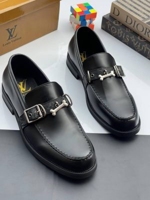 Black Louis Vuitton leather loafers with silver bone buckle hardware displayed with LV box and dice decor.
