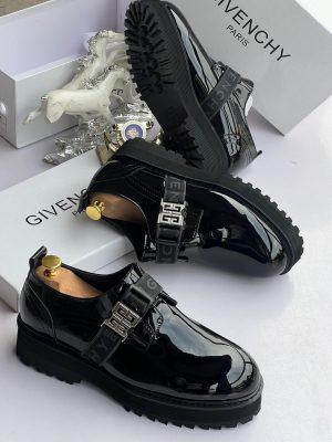 Black Givenchy patent leather loafers with 4G buckle strap and chunky sole displayed with white Givenchy box and horse decor.