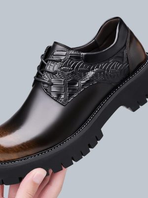 Black leather lace-up formal shoes with crocodile embossed vamp and chunky lug sole displayed on white background.
