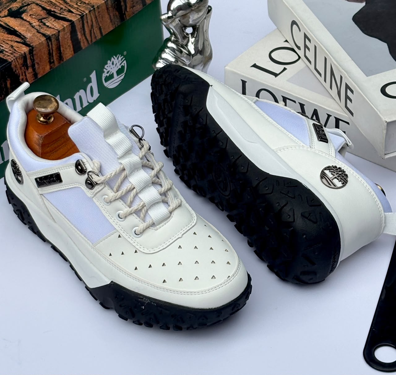 Premium Timberland suede and textile sneakers Men's luxury brown Timberland suede and black textile sneakers with white midsole and rugged black lug outsole sitting in an open shoebox.