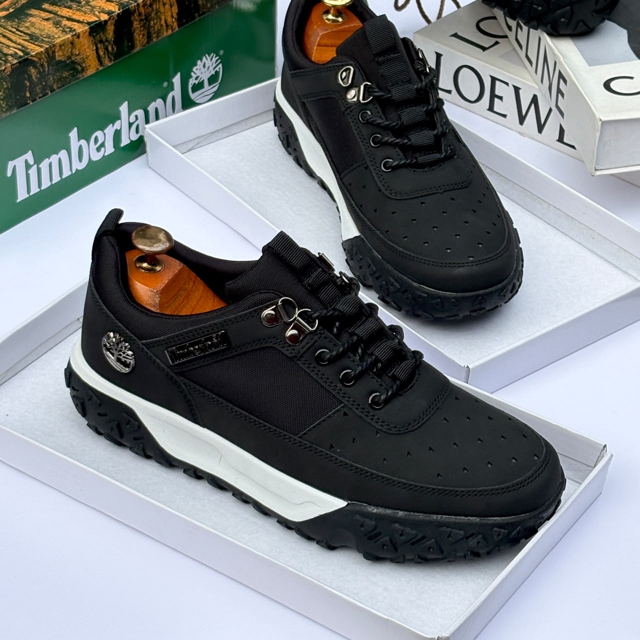 Premium Timberland suede and textile sneakers Men's luxury brown Timberland suede and black textile sneakers with white midsole and rugged black lug outsole sitting in an open shoebox.