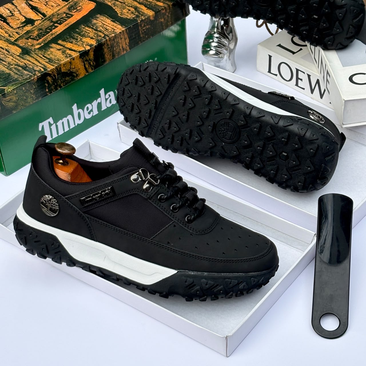 Premium Timberland suede and textile sneakers Men's luxury brown Timberland suede and black textile sneakers with white midsole and rugged black lug outsole sitting in an open shoebox.