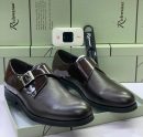 Richwanaz men’s dark brown pebbled leather monk strap shoes with patent strap and silver buckle, displayed beside branded light green box and shoe horn on white surface.