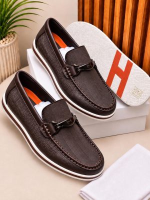 Dark brown men's crocodile-embossed loafers with metallic hardware and white rubber sole.