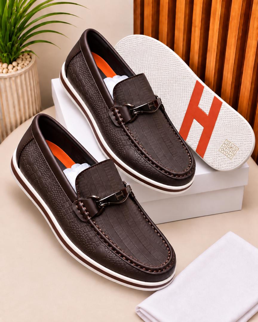 Dark brown crocodile-embossed loafers Dark brown men's crocodile-embossed loafers with metallic hardware and white rubber sole.