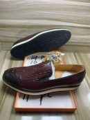 Burgundy leather hybrid loafers with crocodile embossed vamp and white chunky sole displayed in orange box with jewelry.