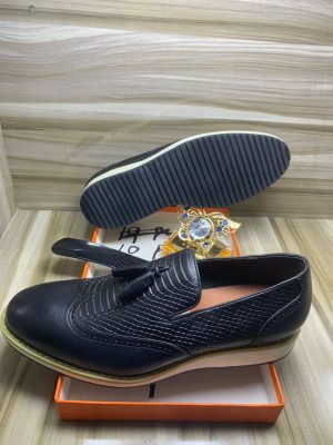 Burgundy leather hybrid loafers with crocodile embossed vamp and white chunky sole displayed in orange box with jewelry.