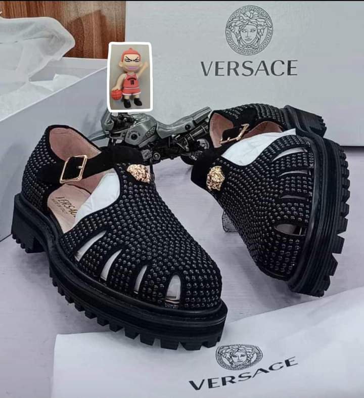 Authentic Versace fisherman sandals Versace men's black leather fisherman sandals with gold Medusa buckle and chunky black rubber lug sole, displayed with white Versace box, dust bag, and authenticity card.