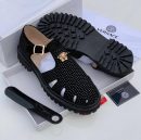 Versace men's black leather fisherman sandals with gold Medusa buckle and chunky black rubber lug sole, displayed with white Versace box, dust bag, and authenticity card.
