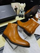 Alfani men's tan leather Chelsea boots with elastic side panels and dark sole, displayed with branded black shoebox and tissue paper on wooden surface.