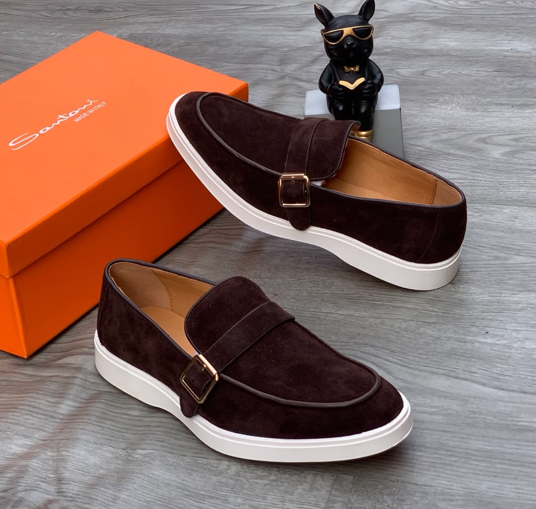 Santoni burgundy suede monk strap sneakers Santoni men's burgundy suede monk strap sneakers with gold buckle and white rubber sole, displayed with orange branded shoebox on grey wood floor.