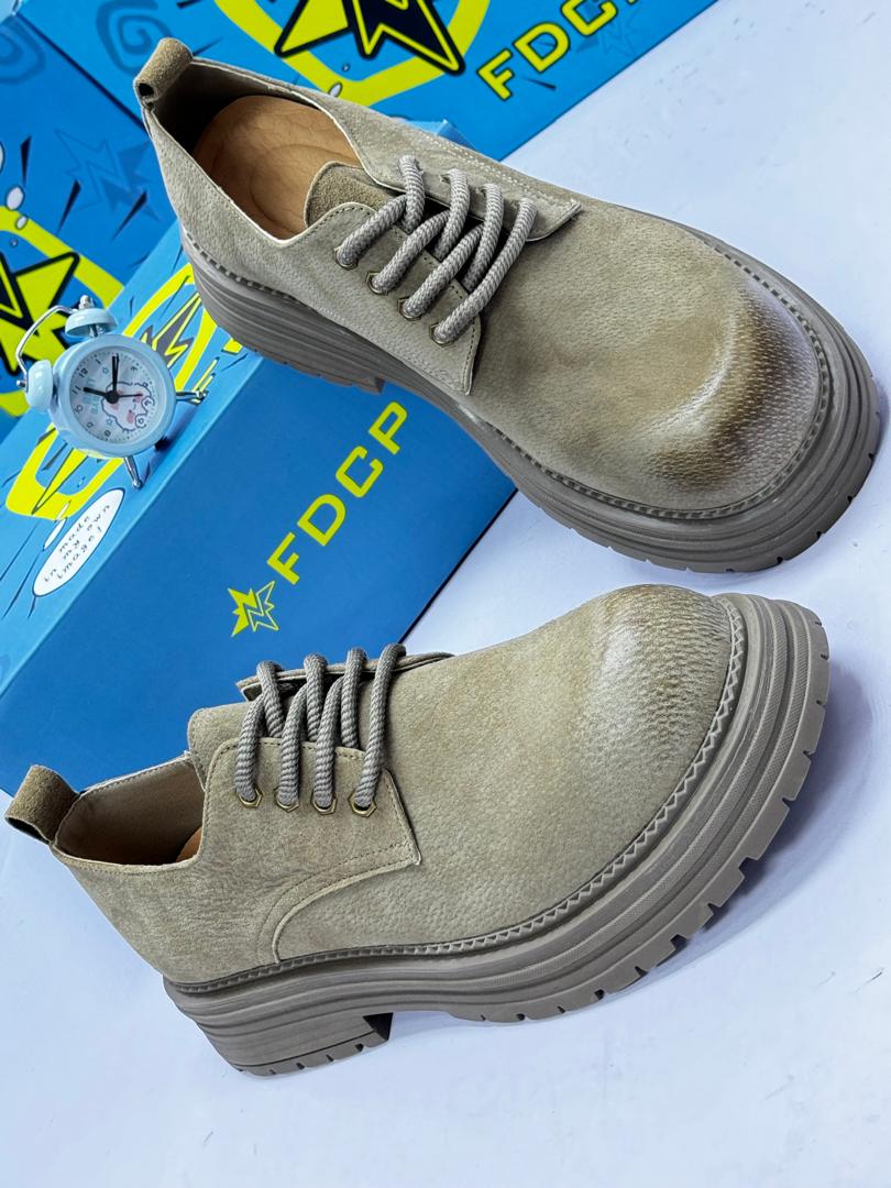 FDCP sage green distressed suede chunky boots FDCP men's sage green distressed suede chunky boots with rope laces and thick ridged platform sole, displayed with blue branded shoebox and vintage alarm clock on white surface.
