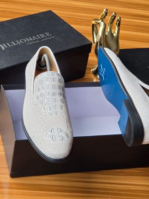 Men's luxury white Billionaire Italian Couture loafers with embossed medallion pattern and blue soles resting on black branded shoeboxes.