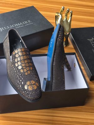Men's luxury dark brown Billionaire Italian Couture loafers with embossed medallion pattern and blue soles resting on black branded shoeboxes.