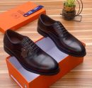 Men's dark brown Franco Binetti cap-toe oxford shoes with decorative stitching and rubber sole, displayed in orange branded shoebox on wooden surface.